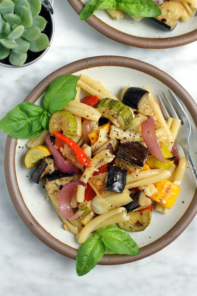 Close-up image of marinated vegetable pasta salad.