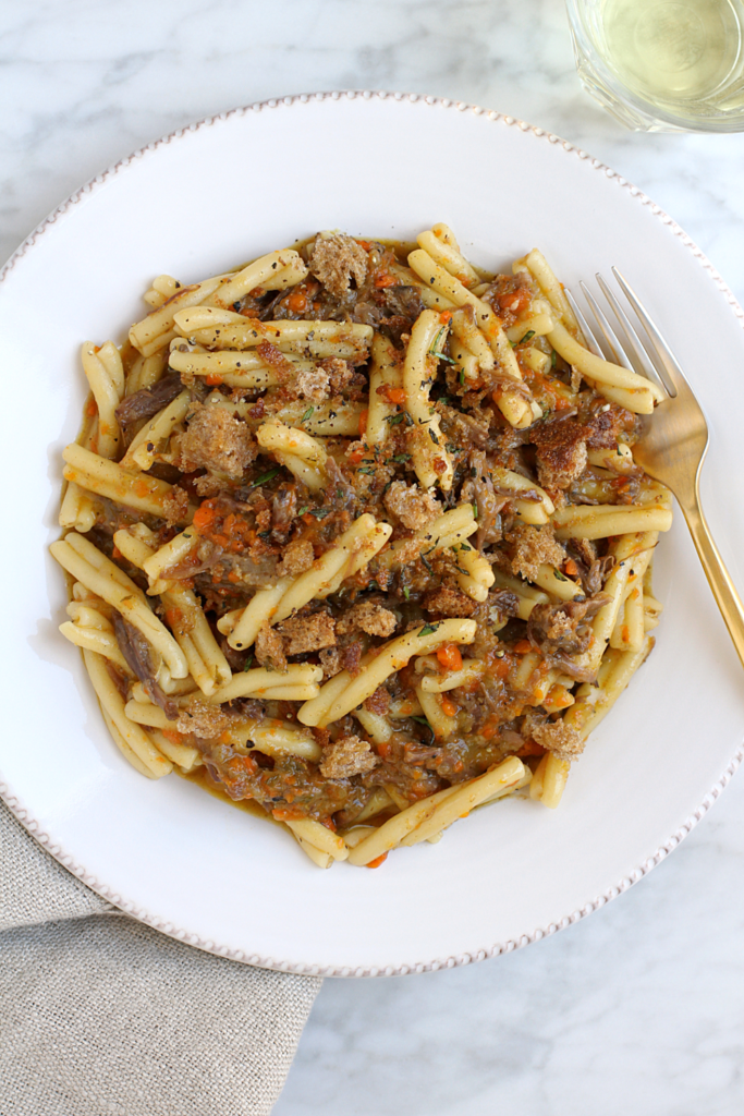 Close-up image of strozzapreti with oxtail ragù.